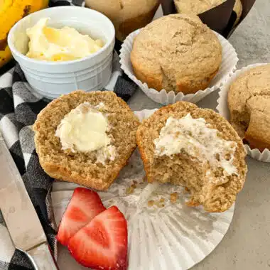 Healthy bran muffin with butter and strawberries for serving.