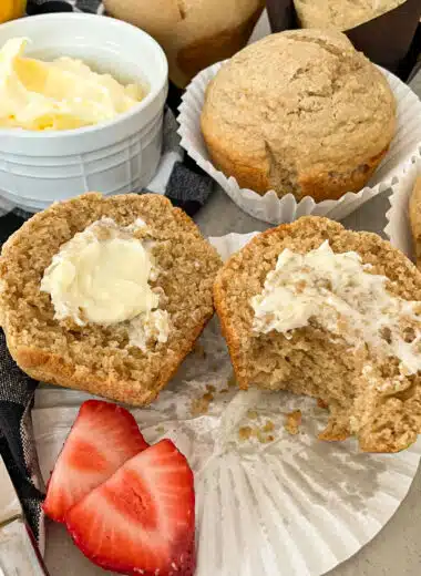 Healthy bran muffin with butter and strawberries for serving.