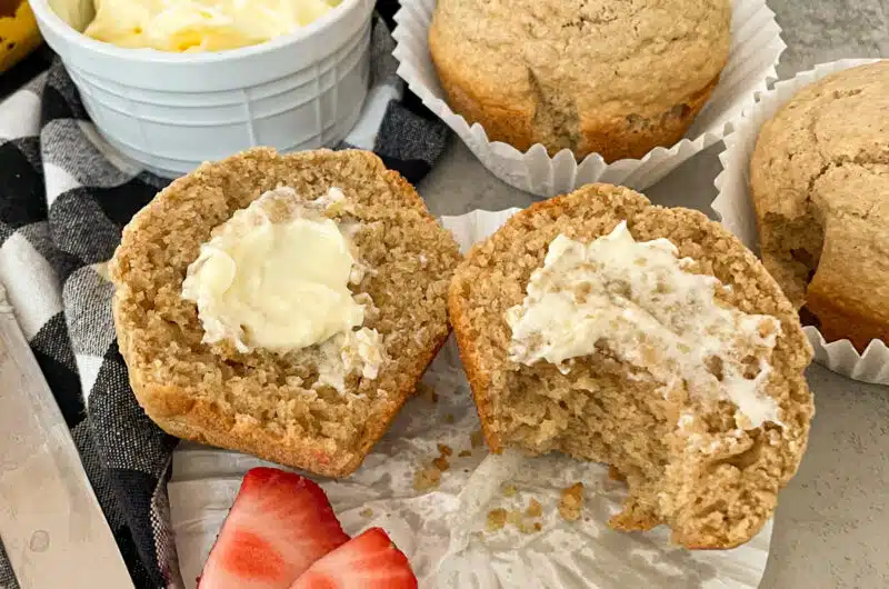 Healthy bran muffin with butter and strawberries for serving.