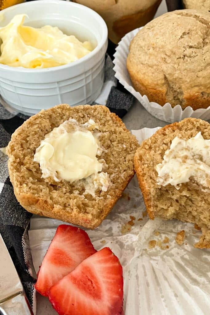 Healthy bran muffin with butter and strawberries for serving.