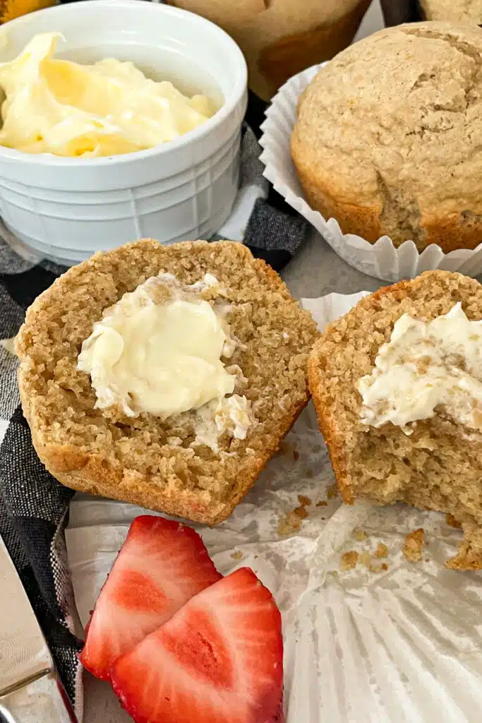 Healthy bran muffin with butter and strawberries for serving.