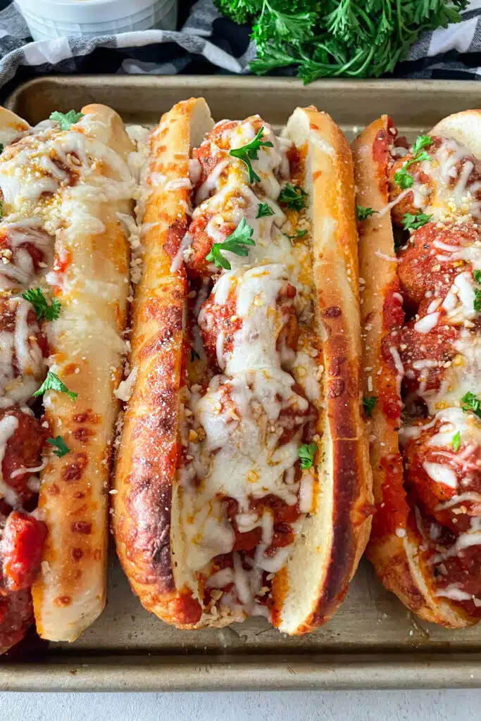 One Italian meatball sub ready to serve with cheese and parsley