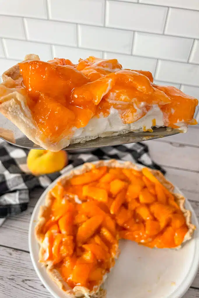 close up photo of a slice of peaches and cream pie