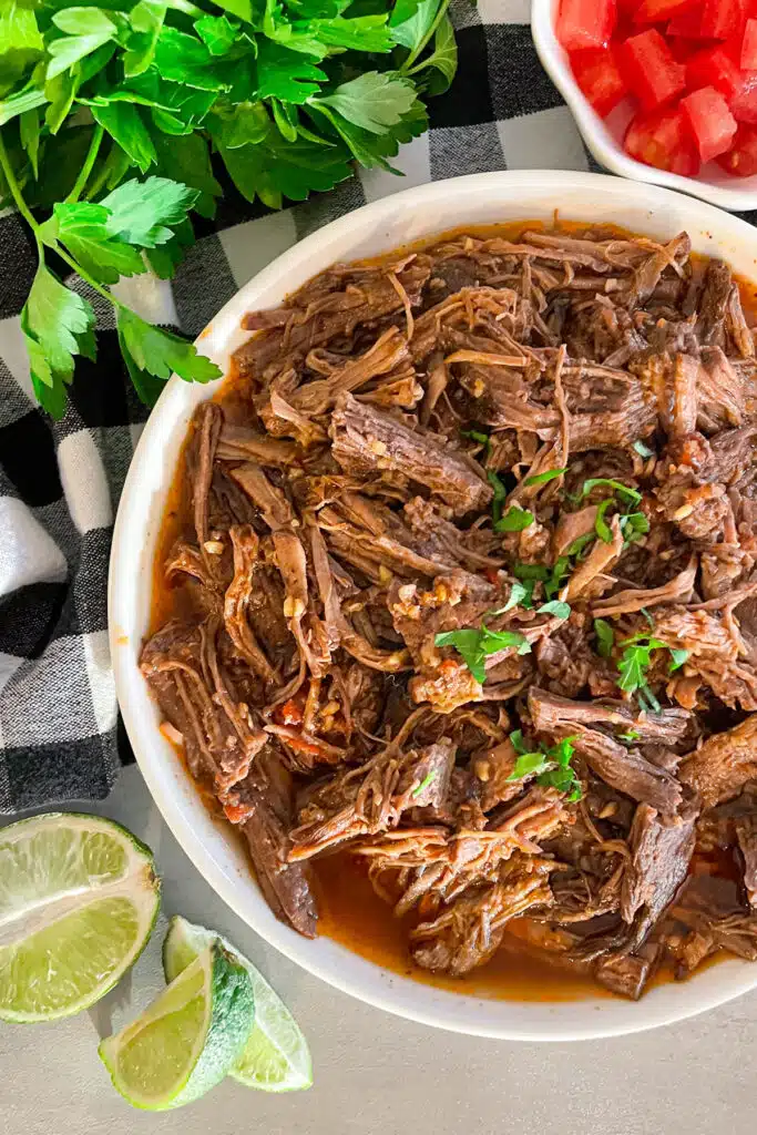 Shredded beef in a white serving dish ready to be eaten