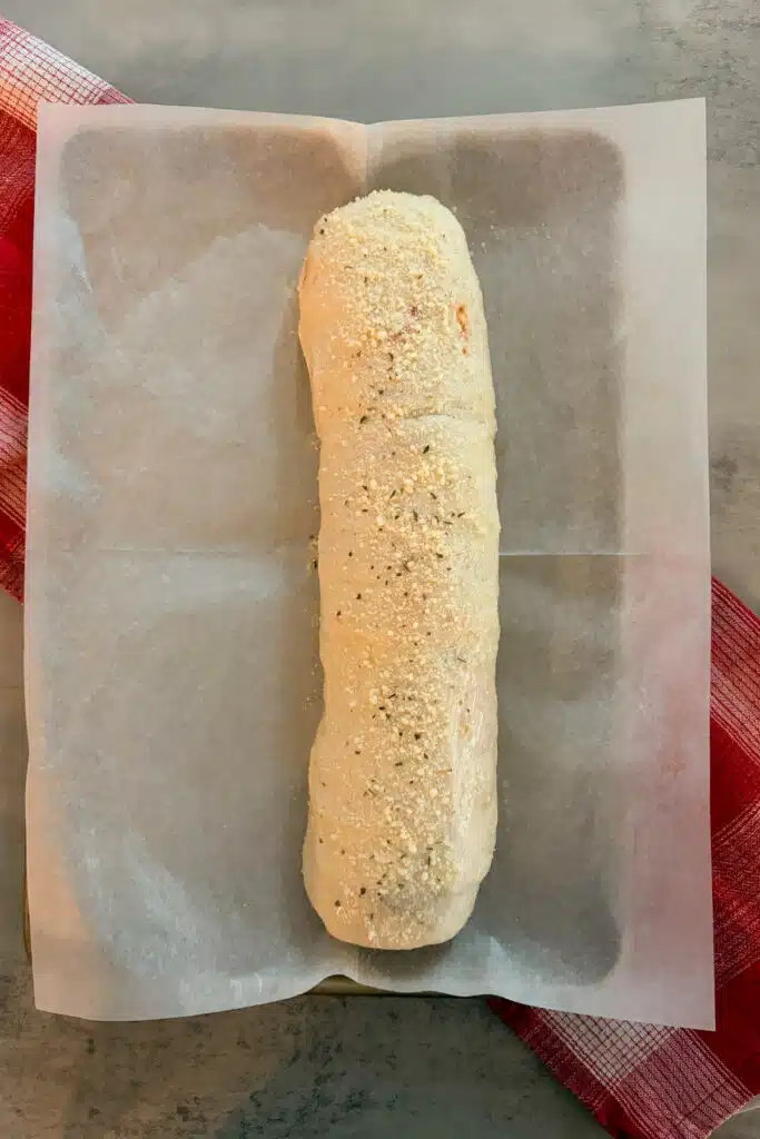stromboli rolled up and ready to be baked in the oven