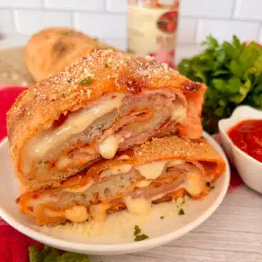 Homemade ham and cheese stromboli cut into slices and ready to serve