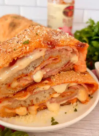 Homemade ham and cheese stromboli cut into slices and ready to serve