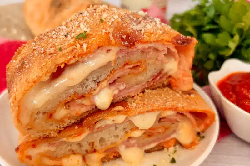 Homemade ham and cheese stromboli cut into slices and ready to serve