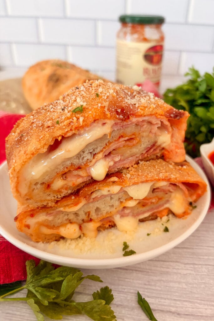 Homemade ham and cheese stromboli cut into slices and ready to serve
