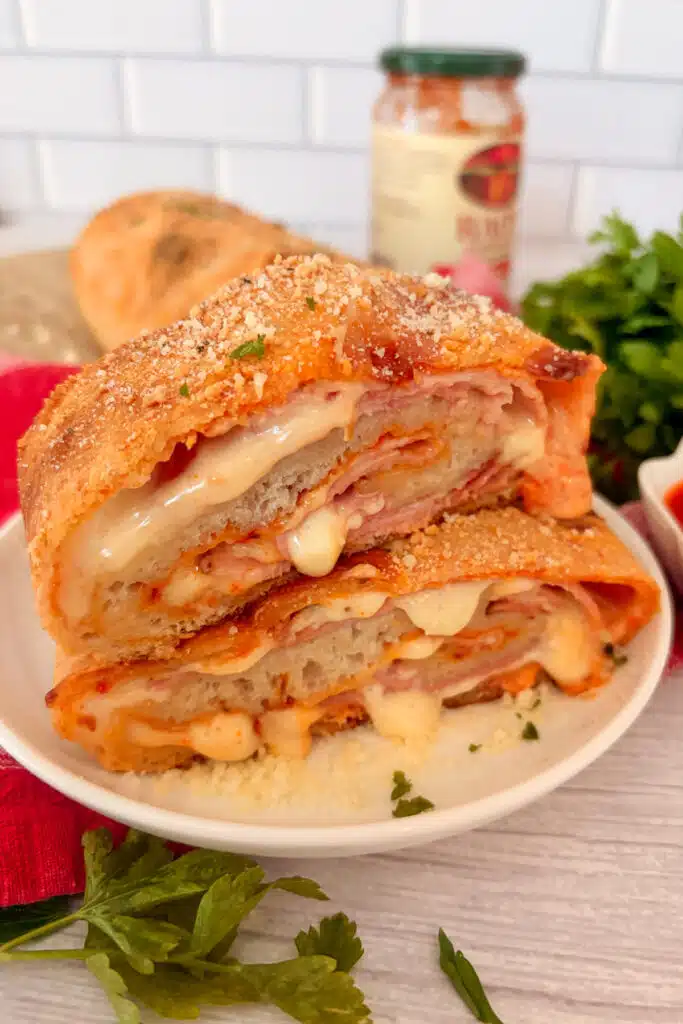 Homemade ham and cheese stromboli cut into slices and ready to serve